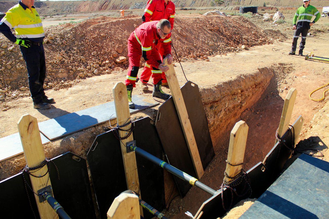 A responder in a rescue suit working a confined space and trench rescue at the mine site